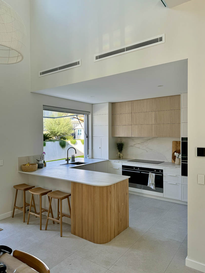 Generous awning with benchtop running in and out acting as servery window into the backyard